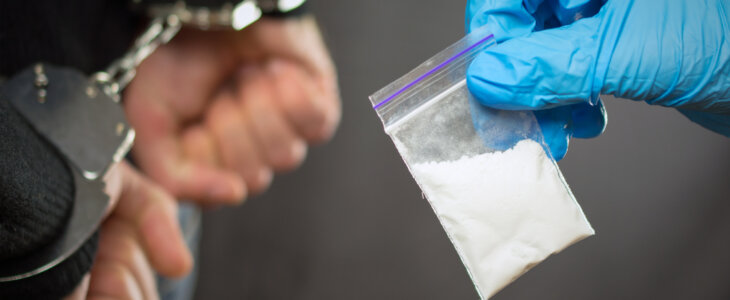 A police officer finds drugs during the search of drug dealers