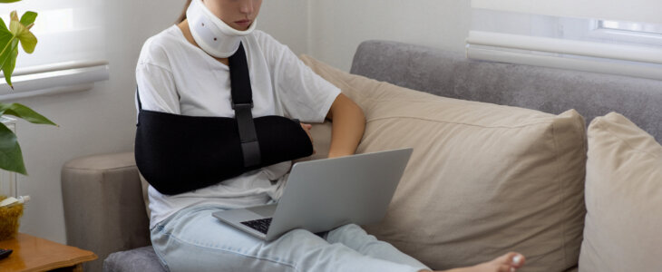 Woman with injured using the laptop